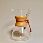 Chemex 6 cup glass pour over coffee maker with wooden collar and leather tie on white background