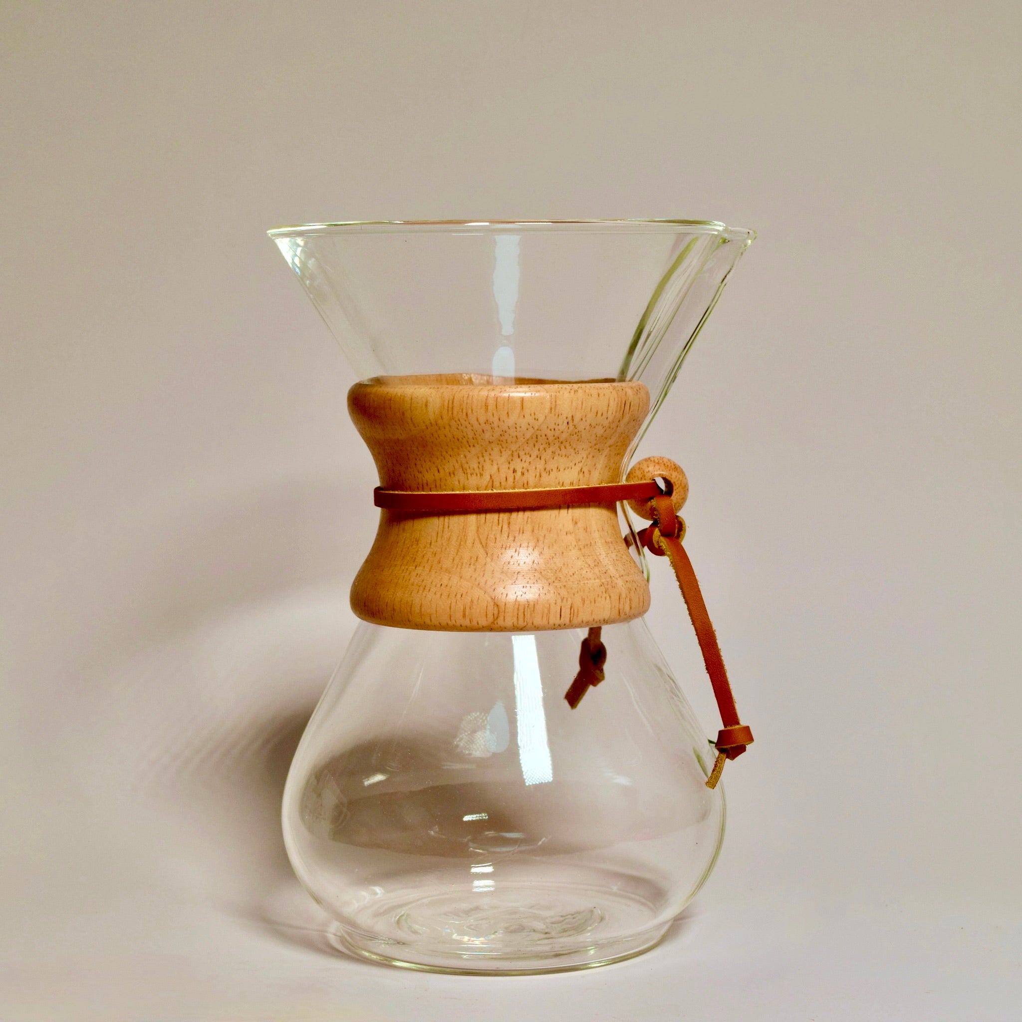 Chemex 6 cup glass pour over coffee maker with wooden collar and leather tie on white background