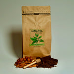 Brown paper bag with 'Coffee Tree Roasters' label, almonds, honey dipper, and coffee grounds 