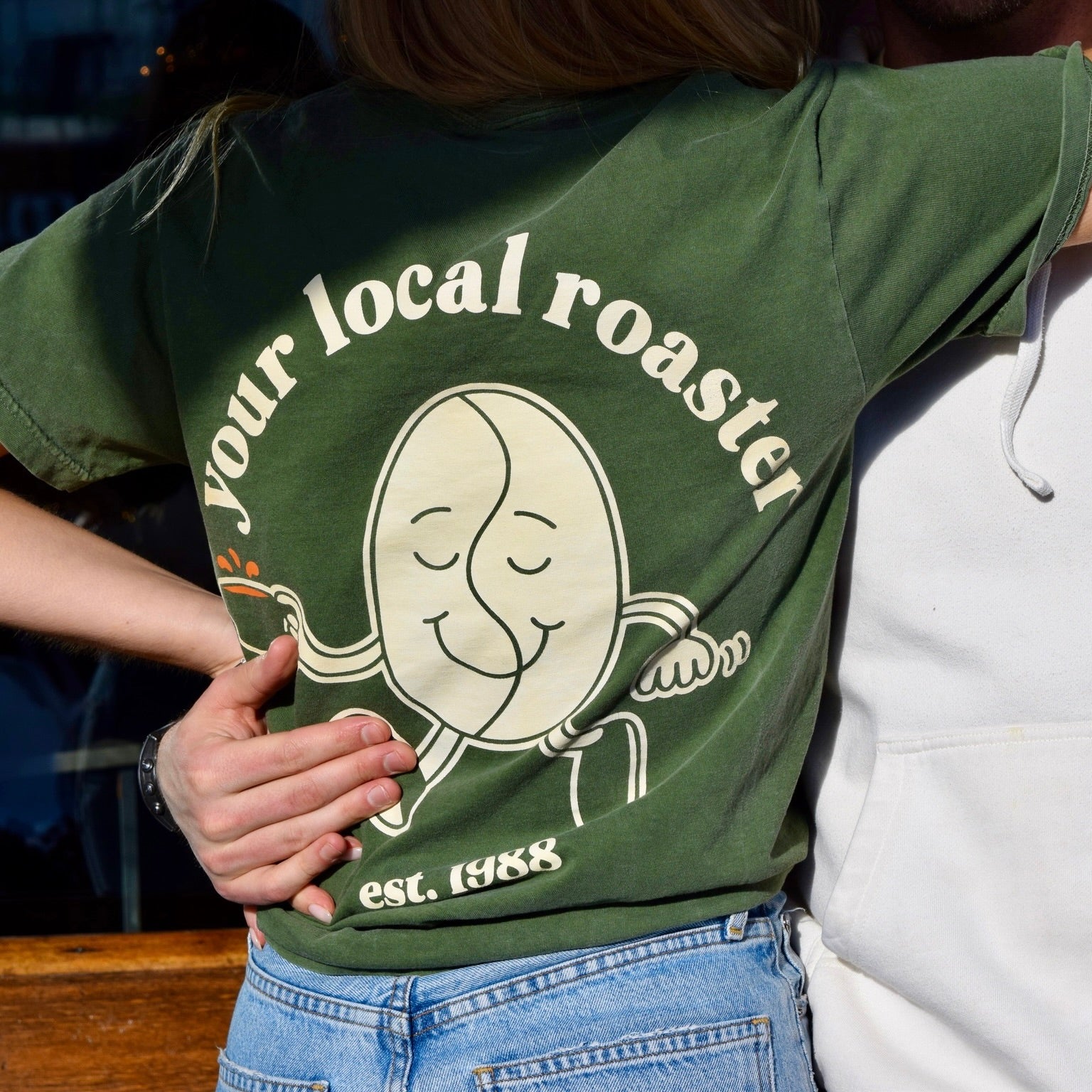 Coffee Tree Roastery t-shirt with “your local roaster” bean character graphic on back
