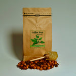 Bag of Heritage Blend coffee with chocolate, nuts, and honey flavour props arranged beside it