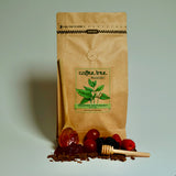 Bag of Honduras microorganism coffee with berry and caramel flavour props arranged beside it