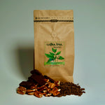 Bag of Mexico Chiapas dark roast coffee with chocolate and stone fruit flavour props arranged beside it
