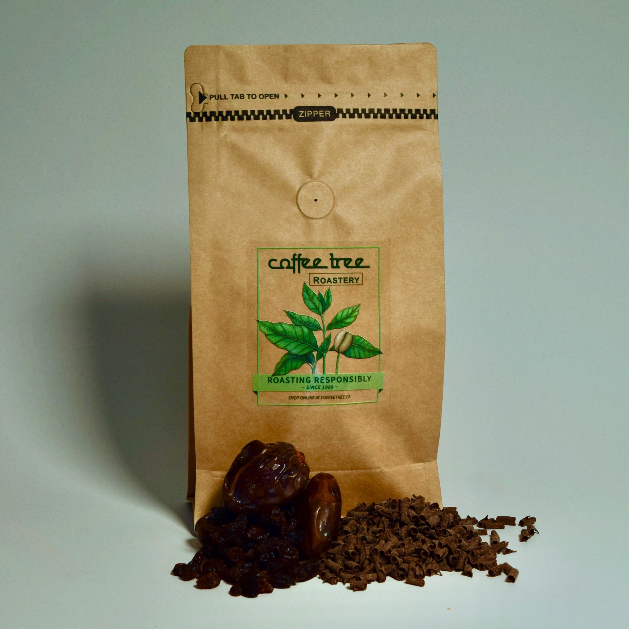 Bag of Mocha Java coffee with chocolate and dates flavour props arranged beside it