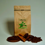 Bag of Yemen Mocha Matari coffee with dark fruit and spice flavour props arranged beside it